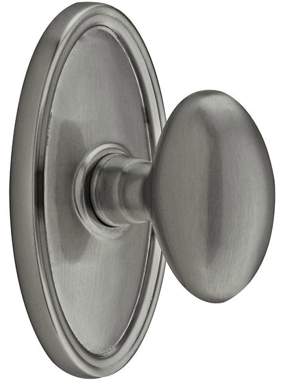 Oval Rosette Set With Elliptical Brass Knobs in Antique Pewter.